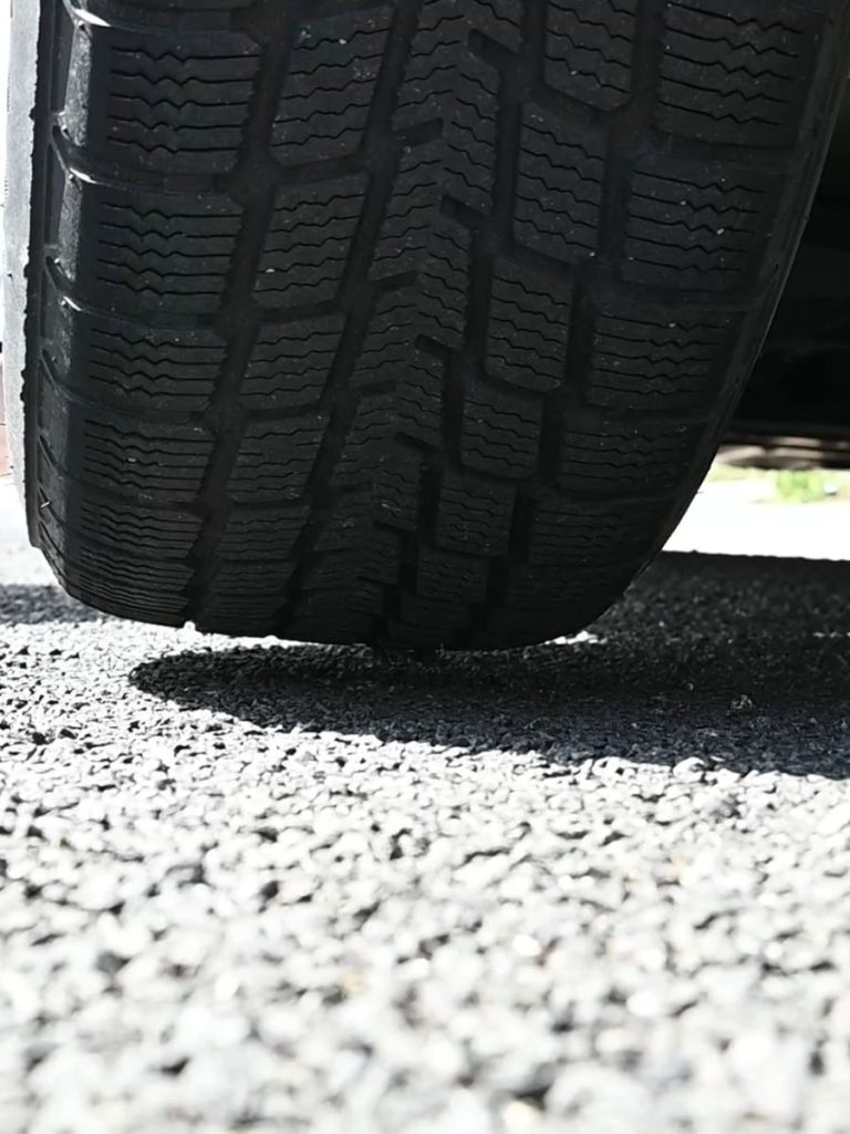 car tire lifted barely off the ground