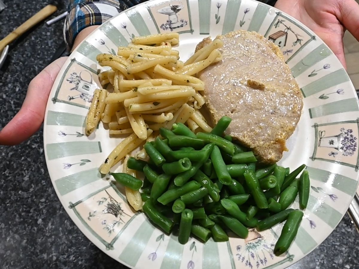 honey mustard pork chops with pasta and green beans on a plate