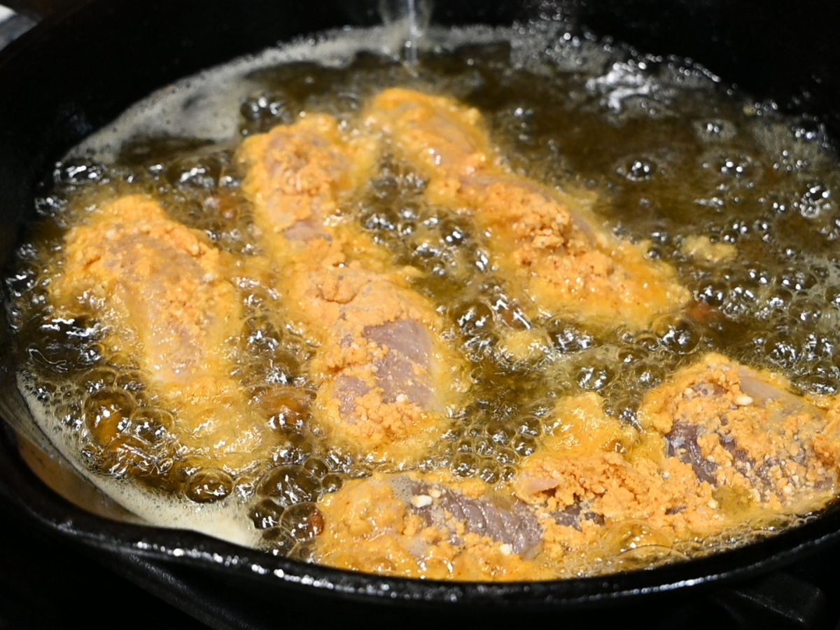 battered-perch-fillets-frying-in-a skillet