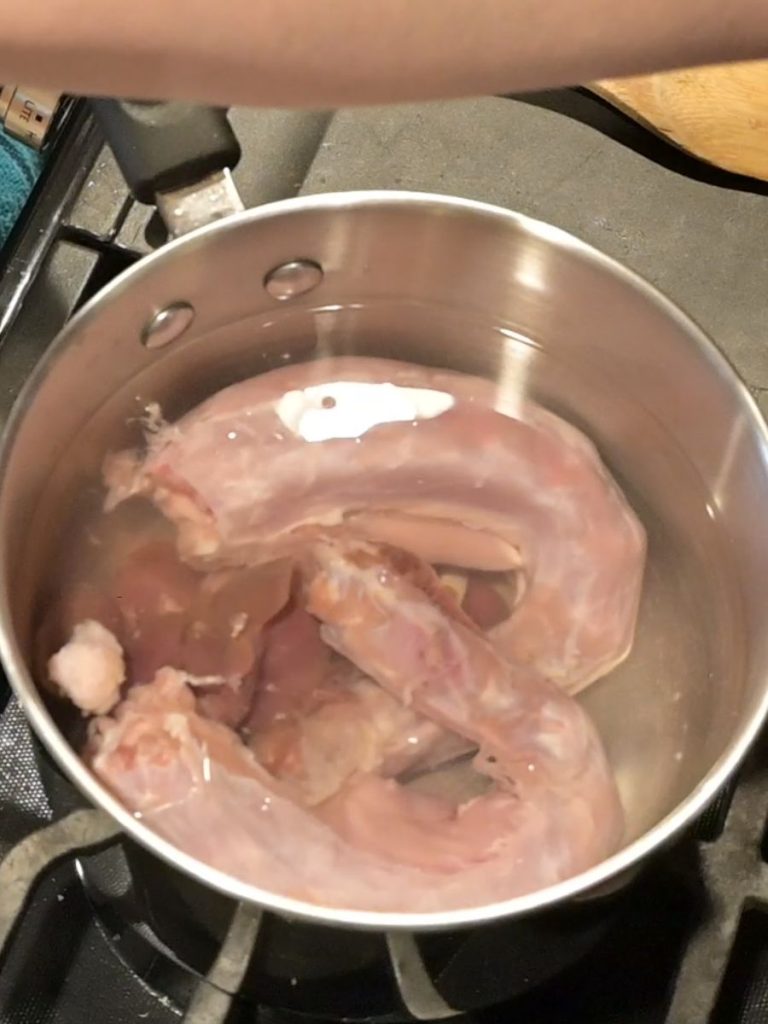 turkey gizzards and neck boiling in a pot of water